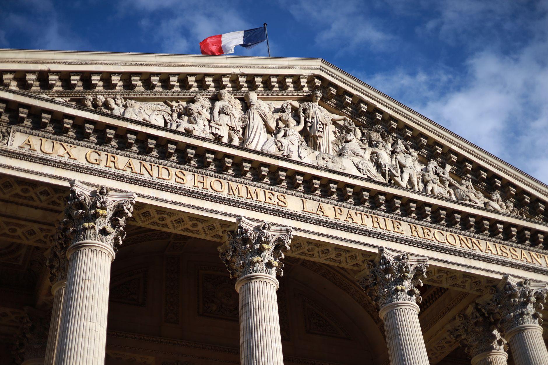 pantheon paris facade with french flag and blue sky